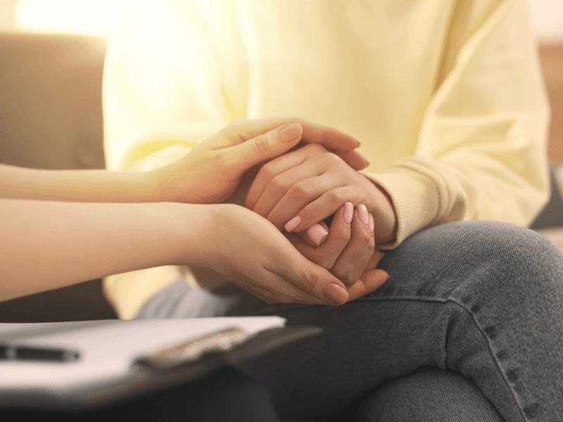 Doctor holding hand with patient